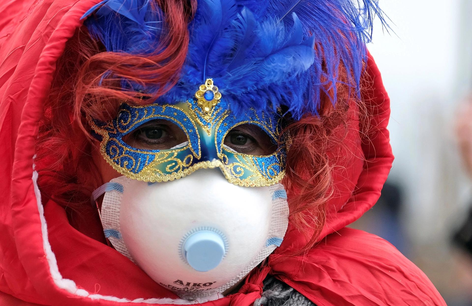 A masked carnival reveller wearing a protective face mask at the Venice Carnival, which was cut short because of an outbreak of coronavirus in northern Italy Photo: REUTERS/Manuel Silvestri