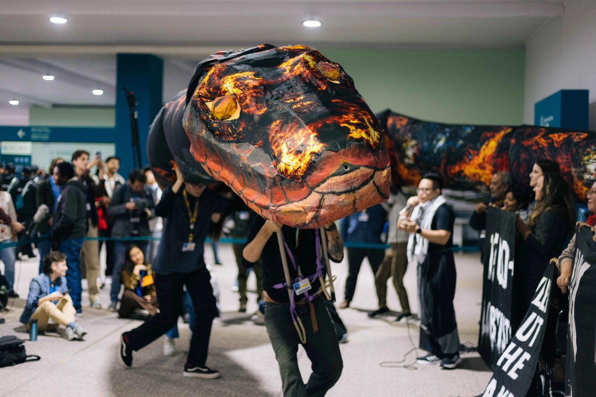 One of the Artivist Network’s actions involved a 15m-long snake designed to draw attention to “the snakes” of the fossil fuel industry present at the event
Photo: Bianca Csenki. Courtesy of Artivist Network