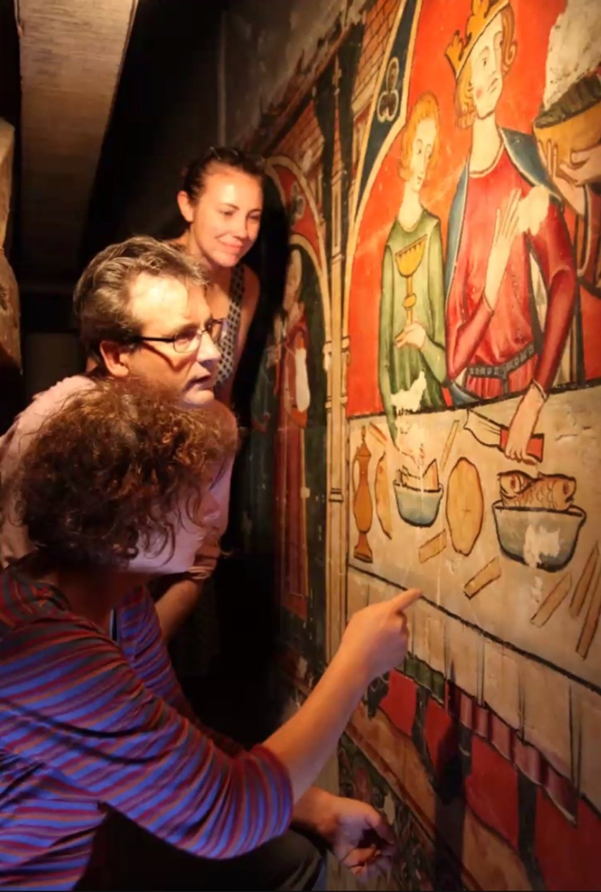 Researchers (left to right) Lucy Wrapson, Paul Binski and Emily Guerry examine the 13th-century wall paintings
Photo: Hamilton Kerr Institute