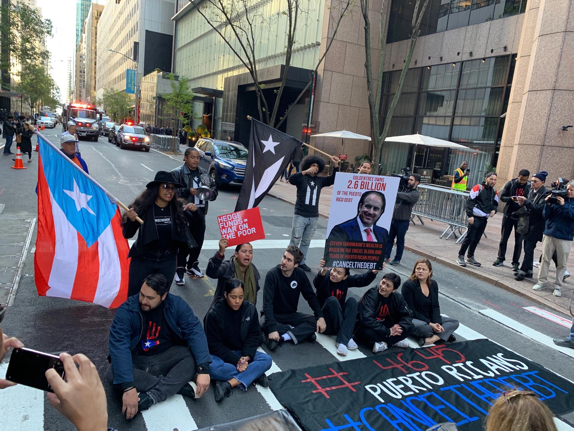 Protesters sat in the middle of 53rd Street as they demanded the removal of Steven Tananbaum from the museum’s board of trustees over his company's involvement in Puerto Rico's debt crisis Zachary Small