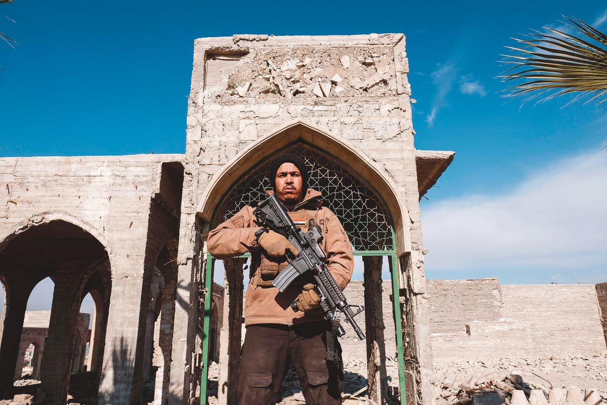 Al Nabi Yunus Mosque in Mosul, guarded by a member of the Iraqi security forces in 2017 NurPhoto SRL/Alamy Stock Photo