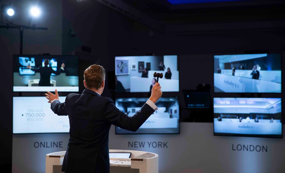 Auctioneer Oliver Barker takes bids from phones and online bidders Courtesy of Sotheby's