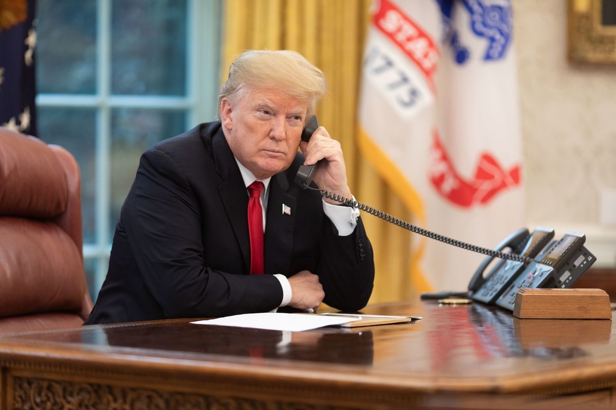 US President Donald Trump takes a phone call at the White House in November 2018, during his first term Official White House Photo by Joyce N. Boghosian, via Flickr