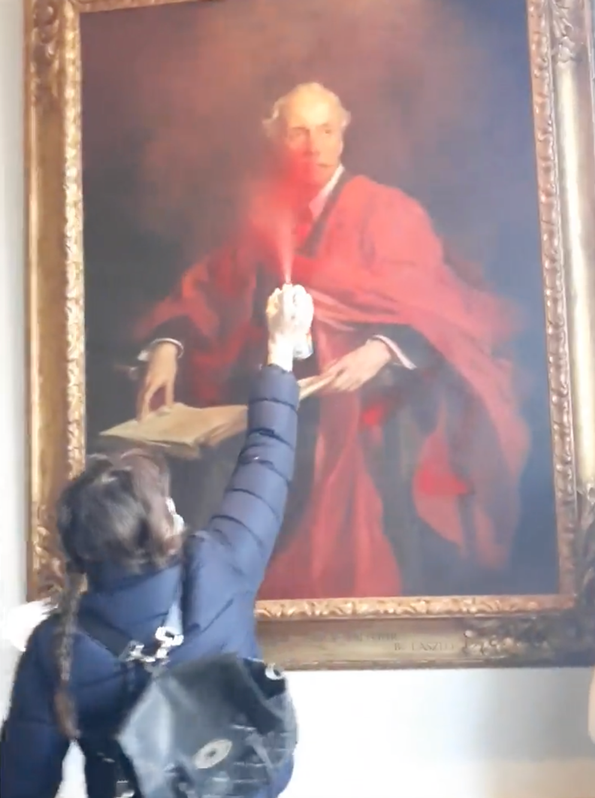 A protestor sprays red paint on the 1914 painting
Photo: Palestine Action