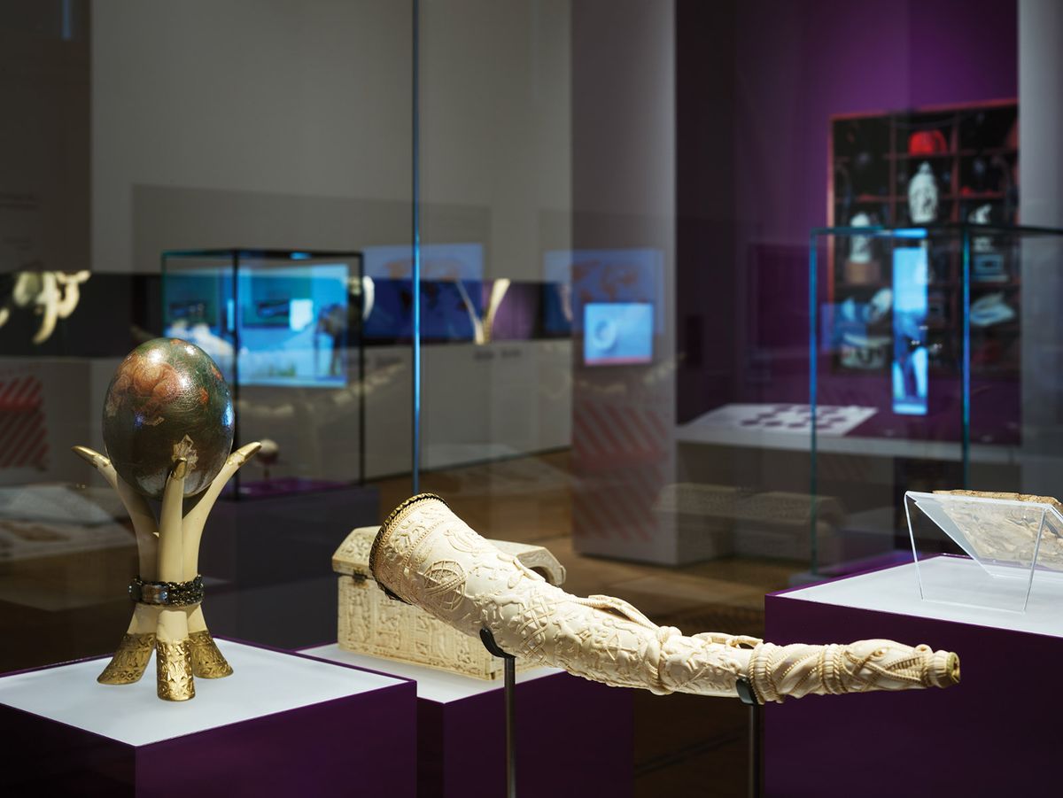 Fine ivory objects are shown alongside chilling images reflecting the scale and violence of elephant poaching. Here, a hunting horn from Sapi, Sierra Leone (around 1490 to 1530) and a painted ostrich egg on a stand made of elephant tusks from Botswana (before 2006) Photo: Ronny Hartmann/AFP via Getty Images