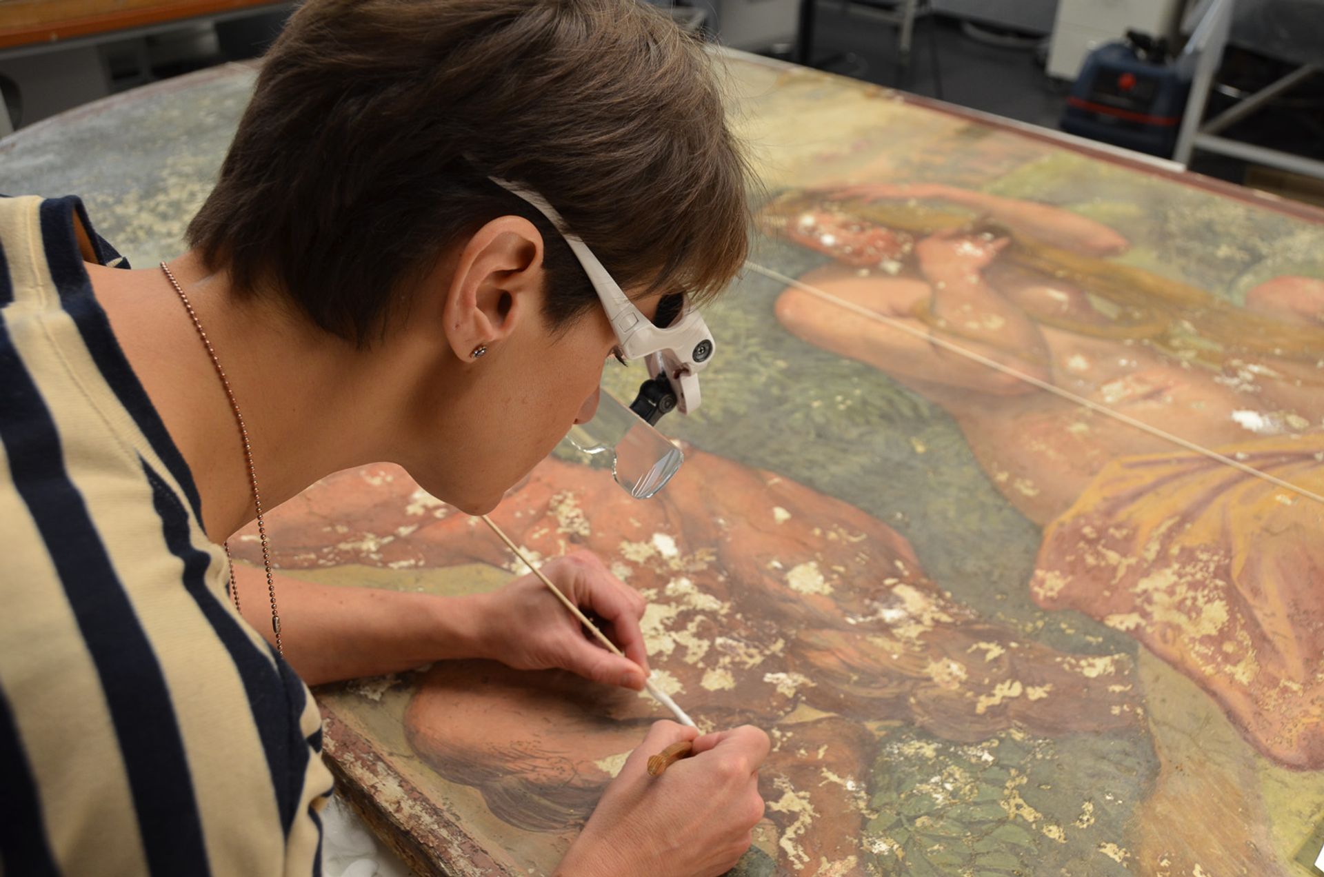 A conservator restoring the school of Raphael fresco Pan and Syrinx © State Hermitage Museum