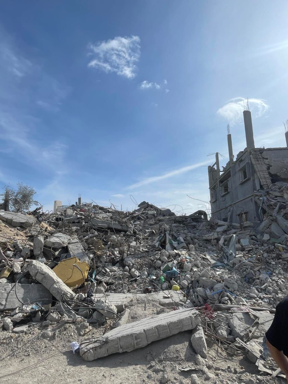 Khaled Hussein returned to his home in Rafah to find it was completely destroyed. He rescued some winter clothes and two of his paintings from the rubble © Khaled Hussein