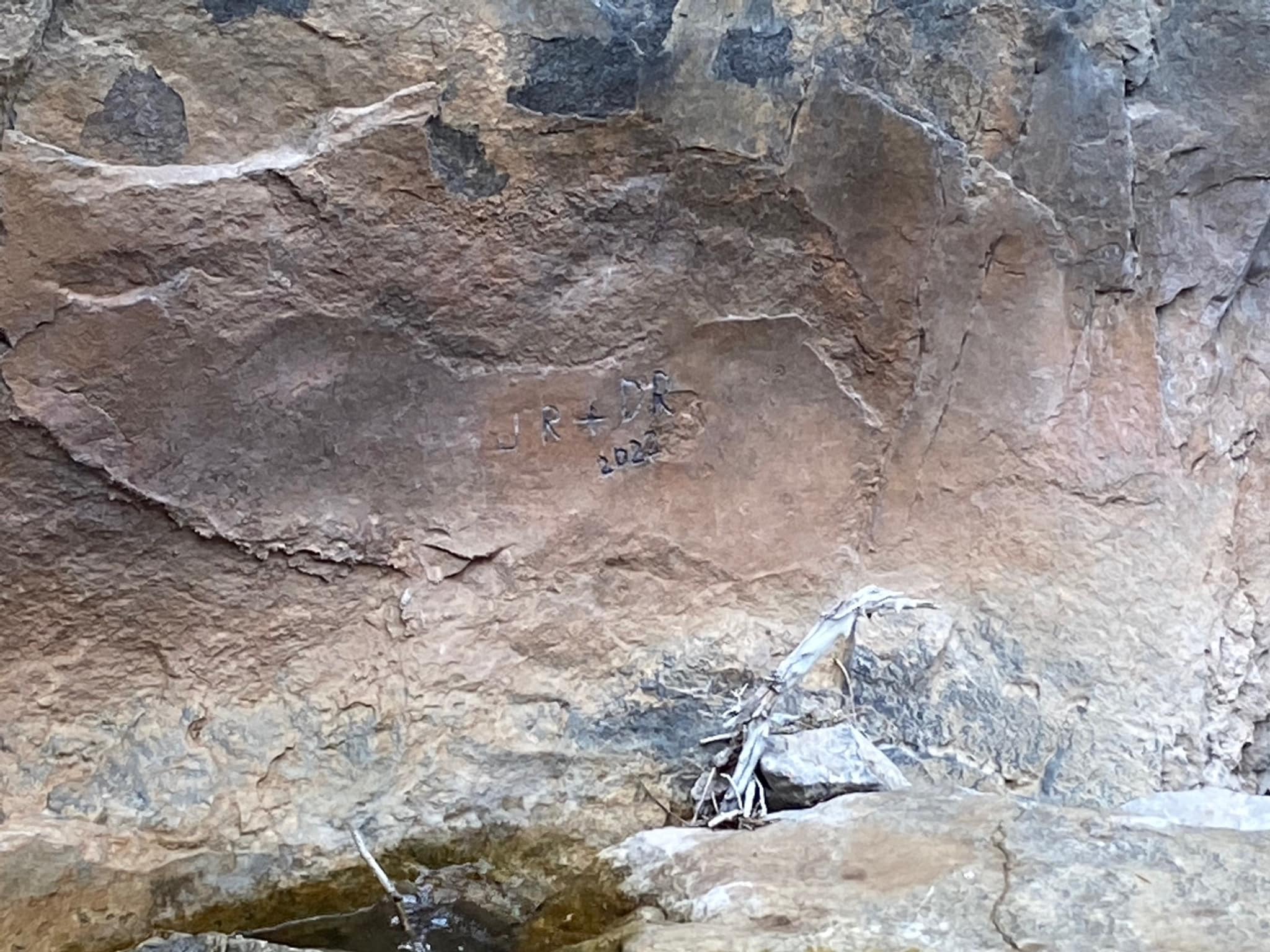 The inititals carved onto a pigment wash of the Hellgate Pictographs panel in the Helena-Lewis and Clark National Forest. Courtesy Helena-Lewis and Clark National Forest Service.