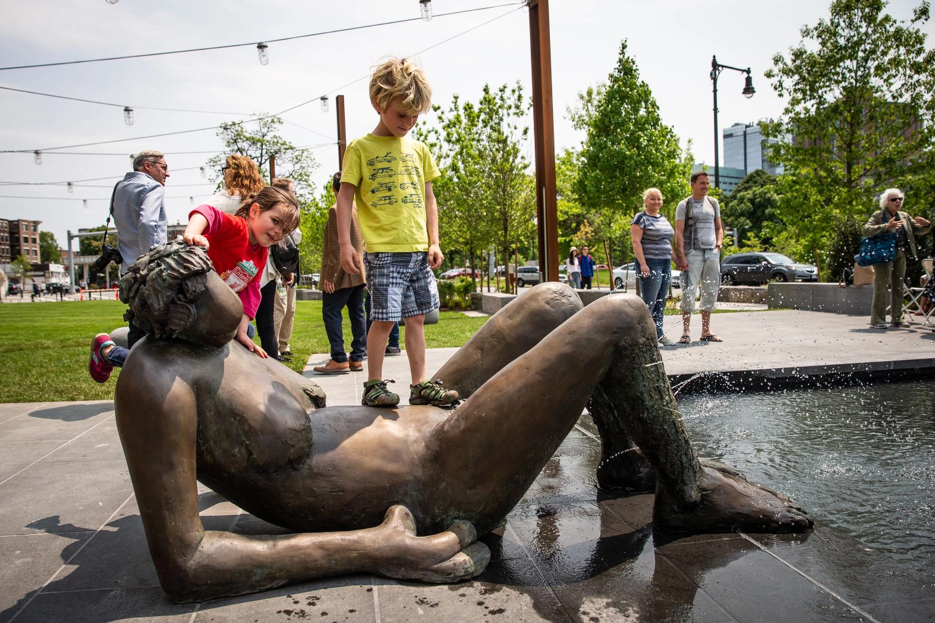 Children playing on Nicole Eisenman's Grouping of Works from Fountain (2017-19), which is now part of the 401 Park Collection owned by Samuels & Associates, Boston Courtesy of Goodman Taft and the artist / Anton Kern Gallery, New York © Nicole Eisenman. Photo: Aram Boghosian