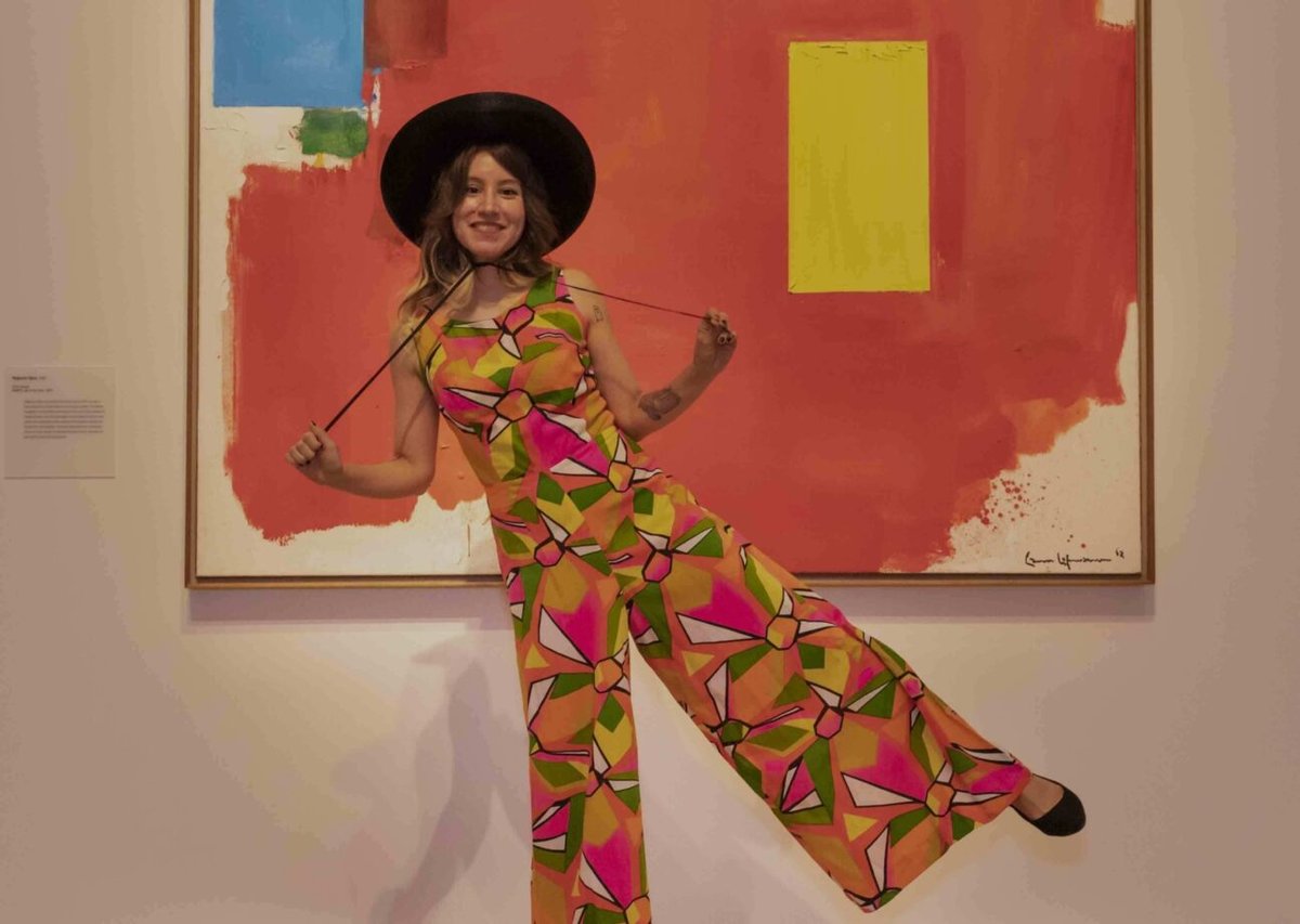 A woman poses with a painting at the Peabody Essex Museum. 
Photo courtesy of the Peabody Essex Museum, Salem, Massachusetts.