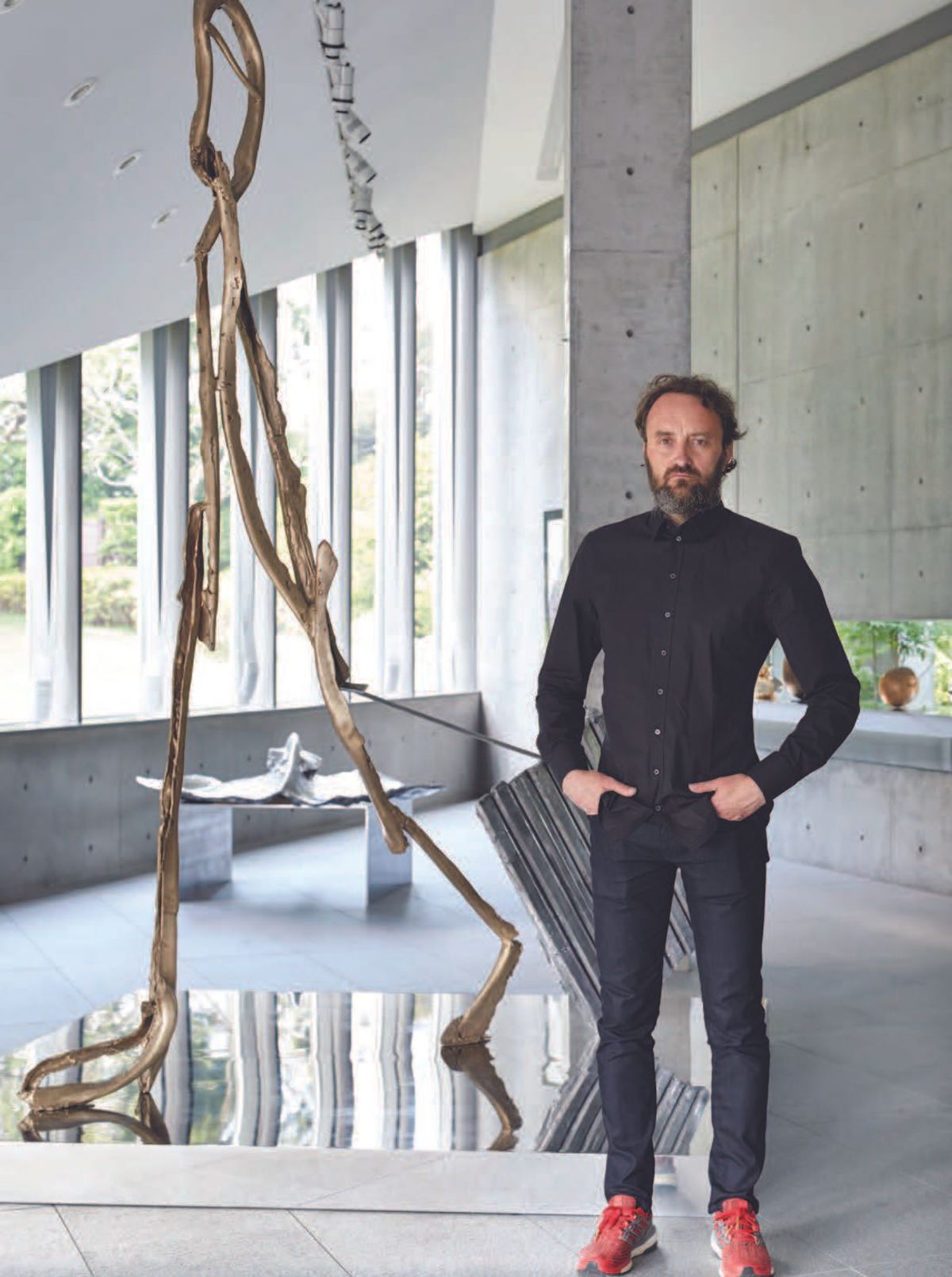 Patrick Roger with his bronze and aluminium sculpture L’homme qui voyage (The man who travels), 2017 