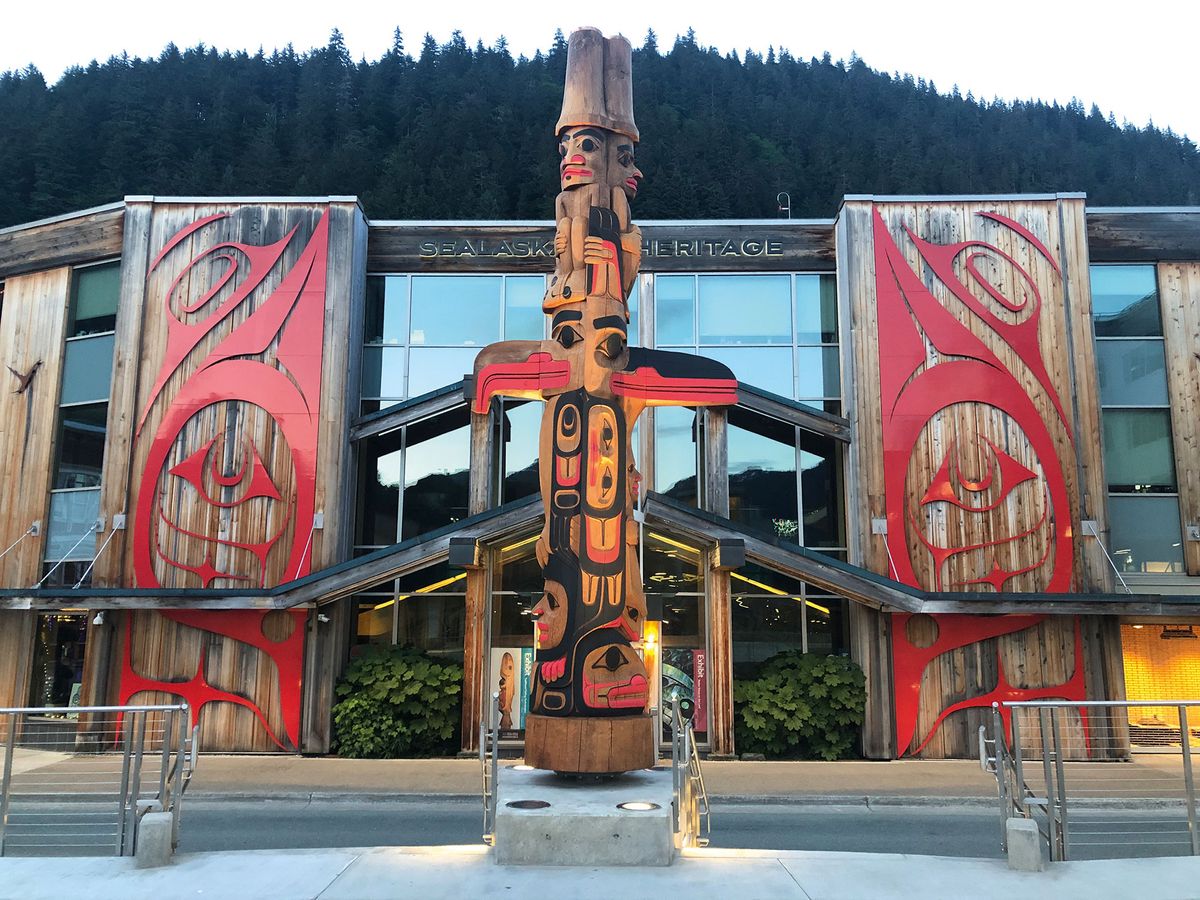 A newly unveiled 360-degree totem pole by Haida carver TJ Young in front of the Walter Soboleff Building in Juneau Art Courtesy of the Sealaska Heritage Institute, photo by Brendan Sainsbury