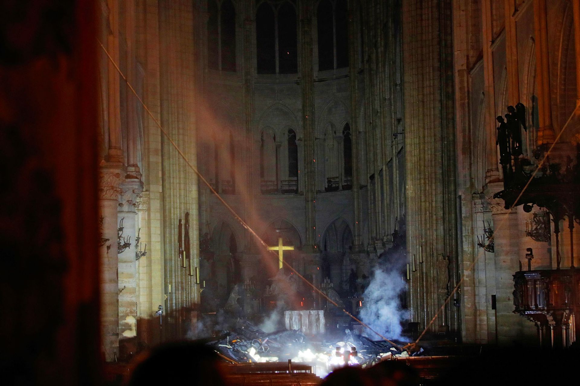 Smoke rising around the altar in front of the cross inside the burning Notre Dame Cathedral on 16 April ©  REUTERS/Philippe Wojazer/Pool