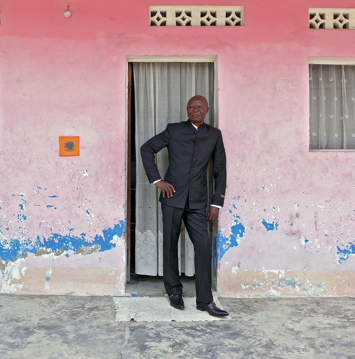 Bodys Isek Kingelez outside his Kinshasa home in 2014 Courtesy of André Magnin, Paris; Photo: Fredi Casco.