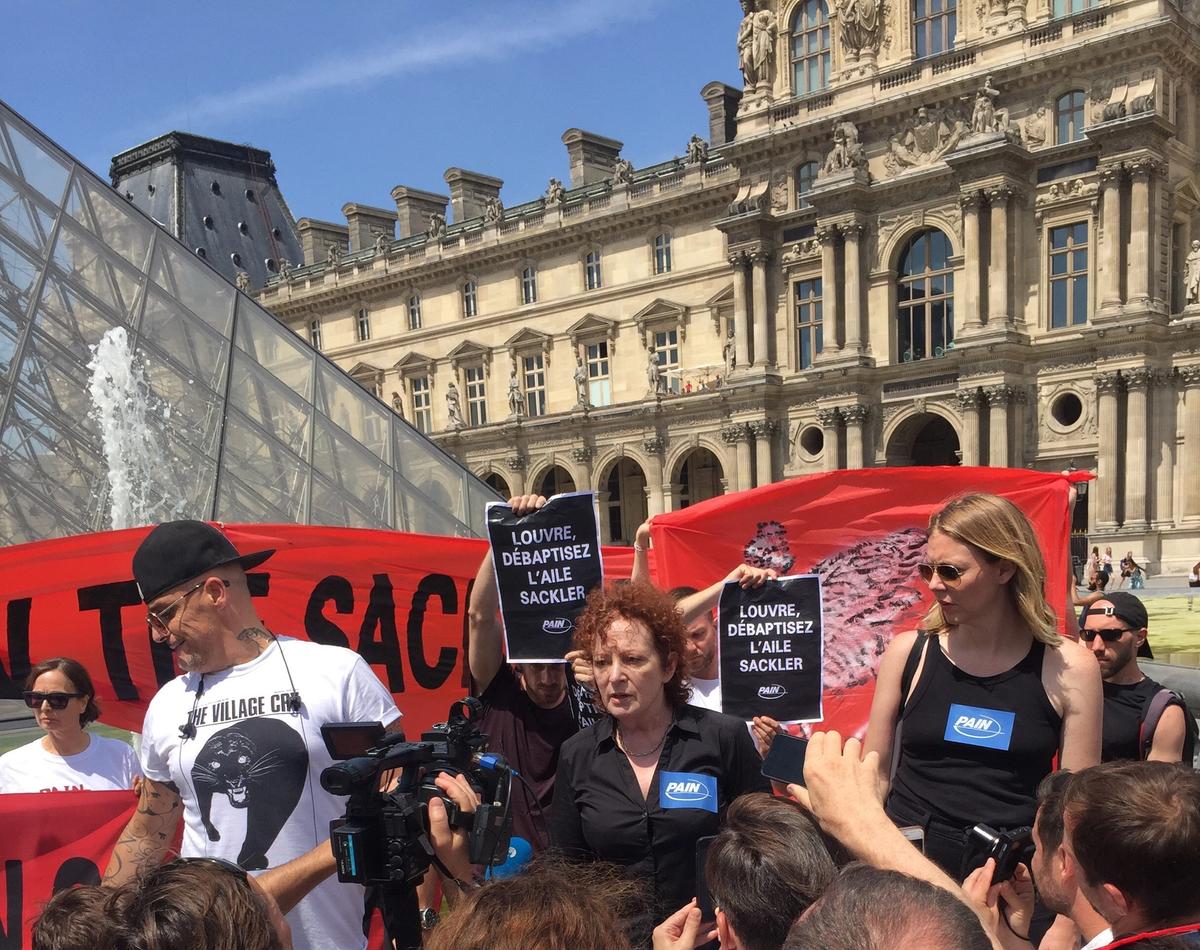 The artist Nan Goldin and members of Pain protesting outside the Musée du Louvre in Paris © Courtesy of Pain
