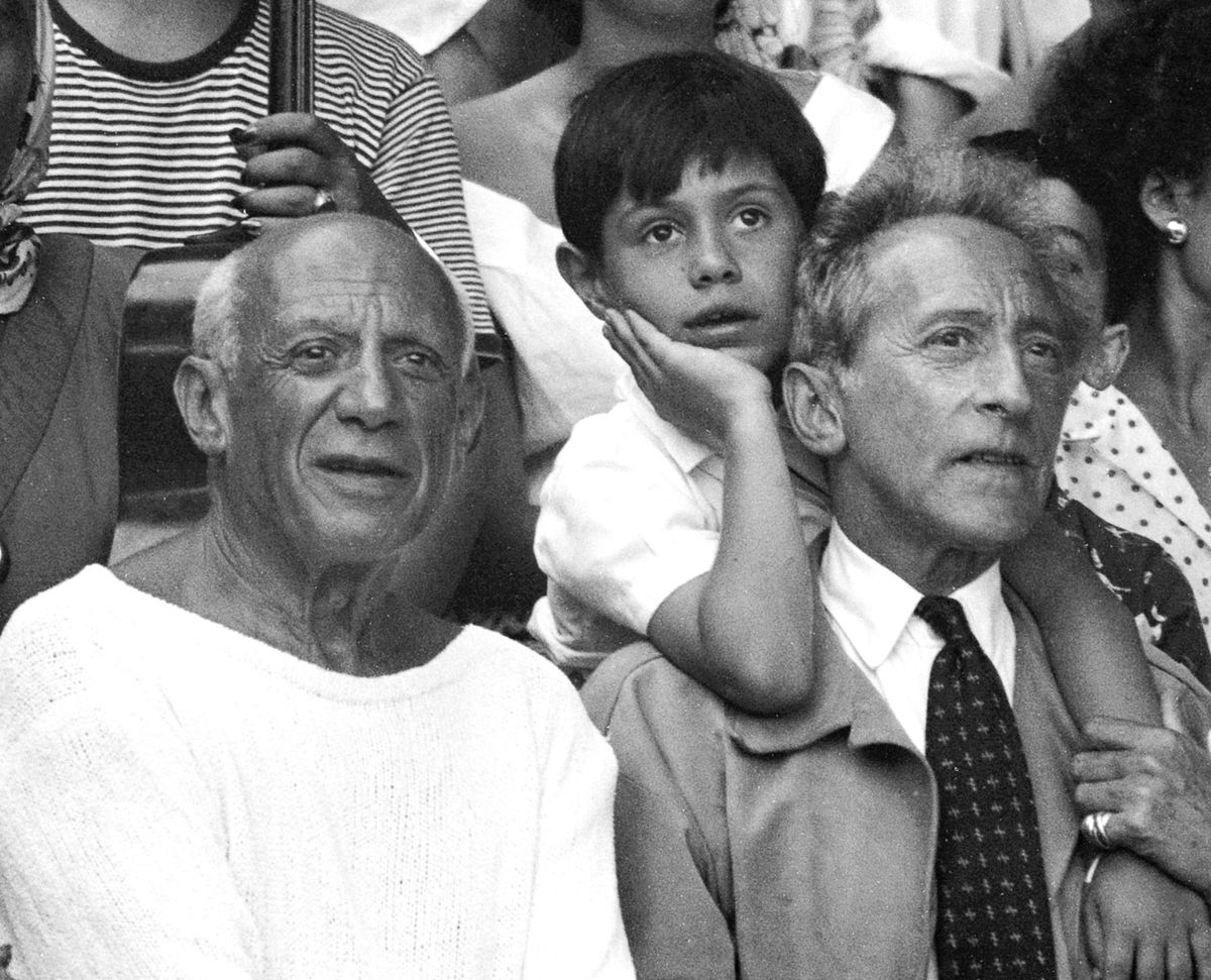Picasso at a bullfight in Vallauris, southeast France, in 1955, with his son Claude and Jean Cocteau Photo: Edward Quinn; © Succession Picasso/DACS, London 2022