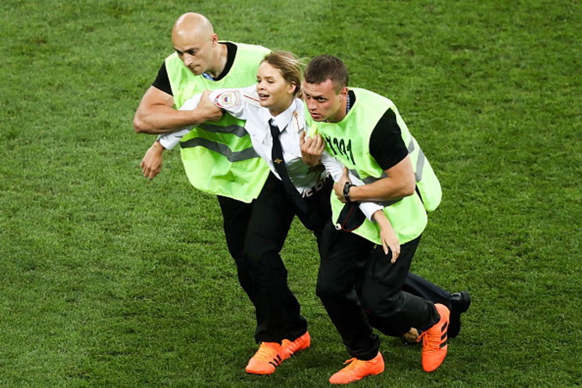 Security guards detain one of the pitch invaders during the 2018 FIFA World Cup final match at Luzhniki stadium in Moscow Stanislav Krasilnikov/TASS via Getty Images