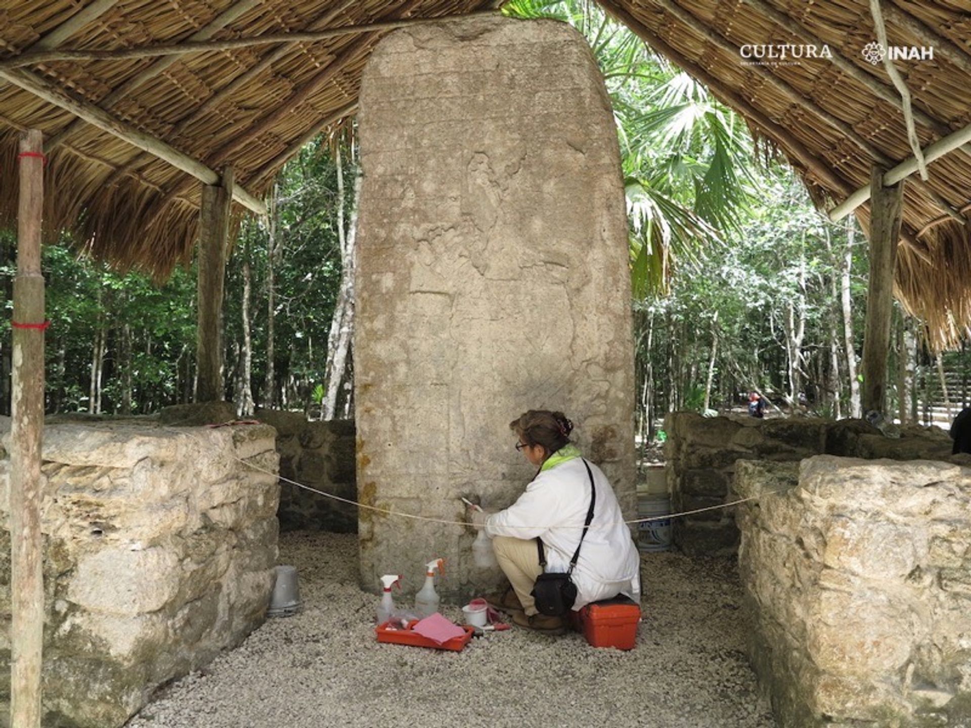 A conservator works on an inscribed stele at Cobá Photo: Mónica López Portillo