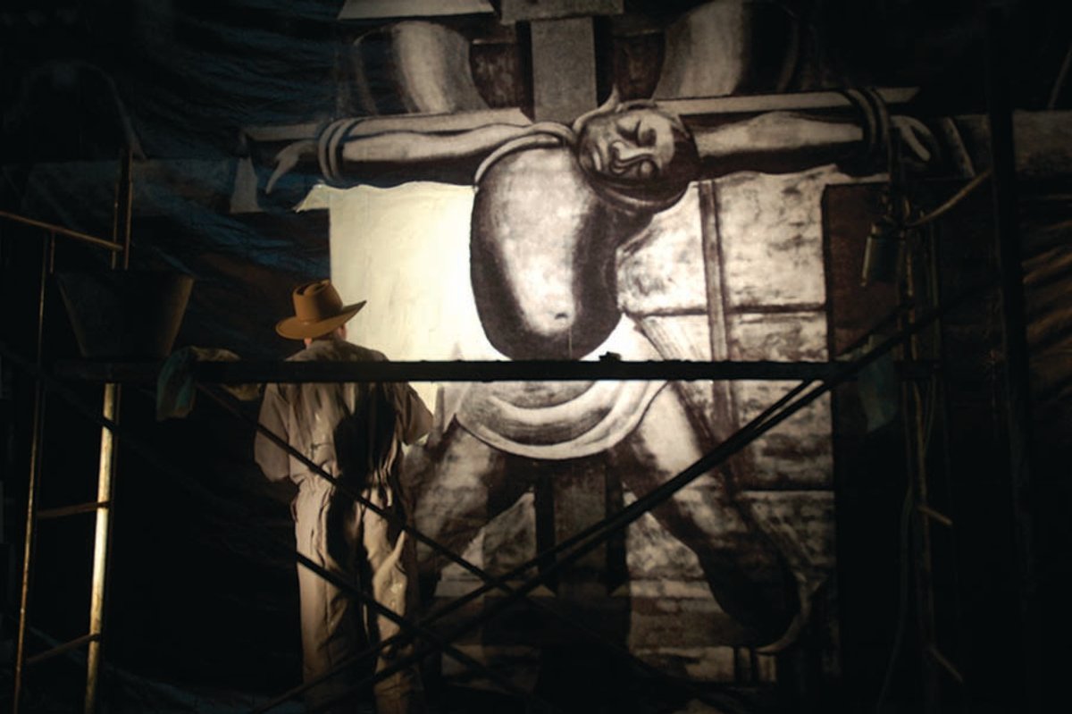 A still from the film recreating Siqueiros secretly finishing the central figure in his iconic "America Tropical" mural in LA. Lorena Manriquez