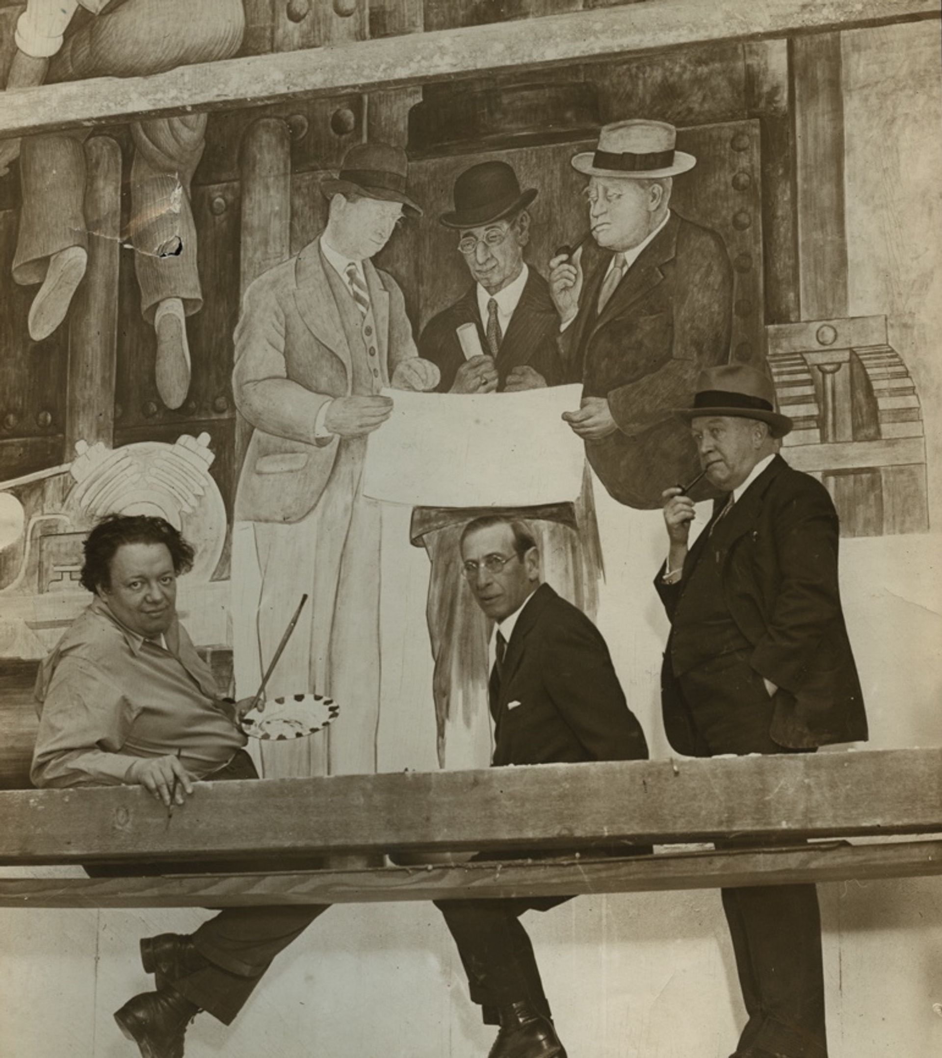 Diego Rivera in front of The Making of a Fresco, Showing the Building of a City in 1931. Courtesy of San Francisco Art Institute.