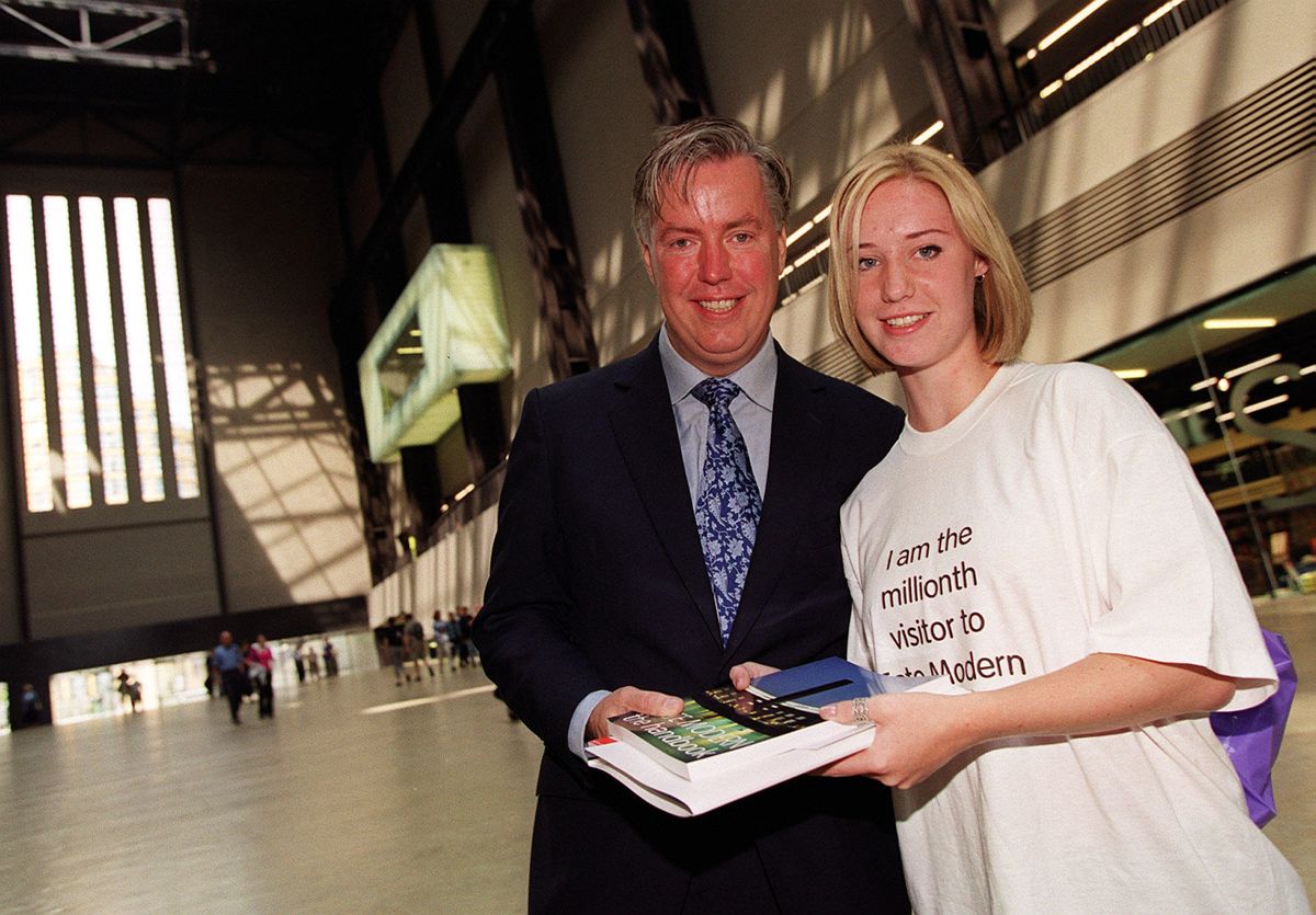 Laura Horwood, 17, who became the one millionth visitor to the Tate Modern in London receives a bundle of free gifts and a 5-year Tate membership by Tate director Lars Nittve. The acclaimed 134 million building in London is way ahead of targets after initially estimating only two million people would want to see the building and its world renowned art works within the first year. Laura was on a visit with her fellow students from Rickmansworth School, Hertfordshire, when she was stopped on the way in by Tate director Lars Nittve. Photo: Michael Crabtree, 27 June 2000