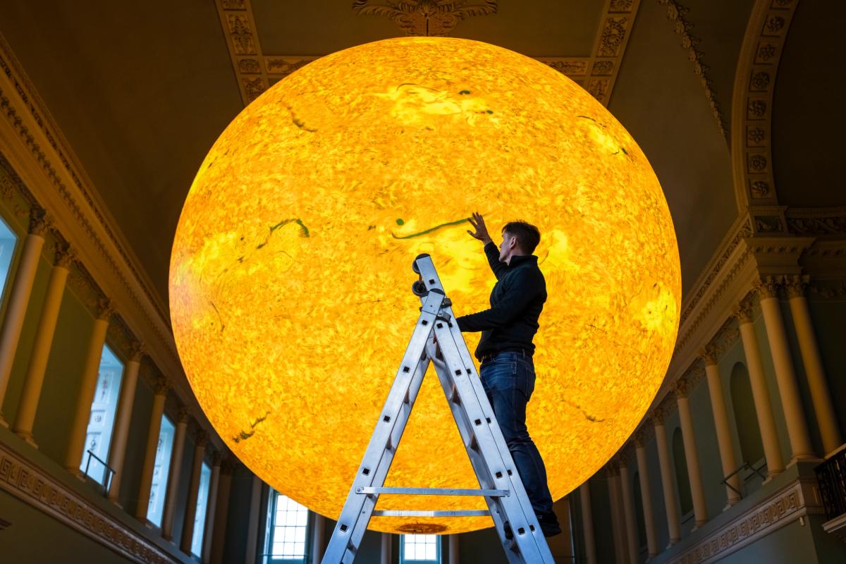 Artist Luke Jerram with Helios, a work co-commissioned by the National Trust, in Bath Assembly Rooms
©National Trust Images, James Dobson