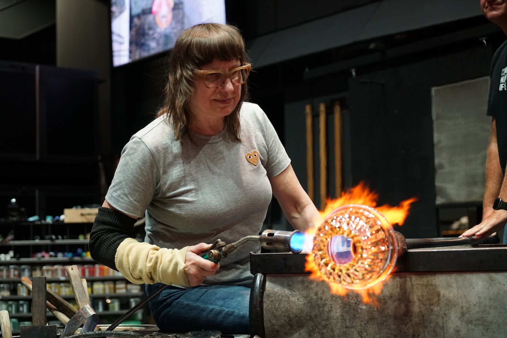 Deborah Czeresko working a glass hubcap at the Corning Museum of Glass Courtesy of The Corning Museum of Glass