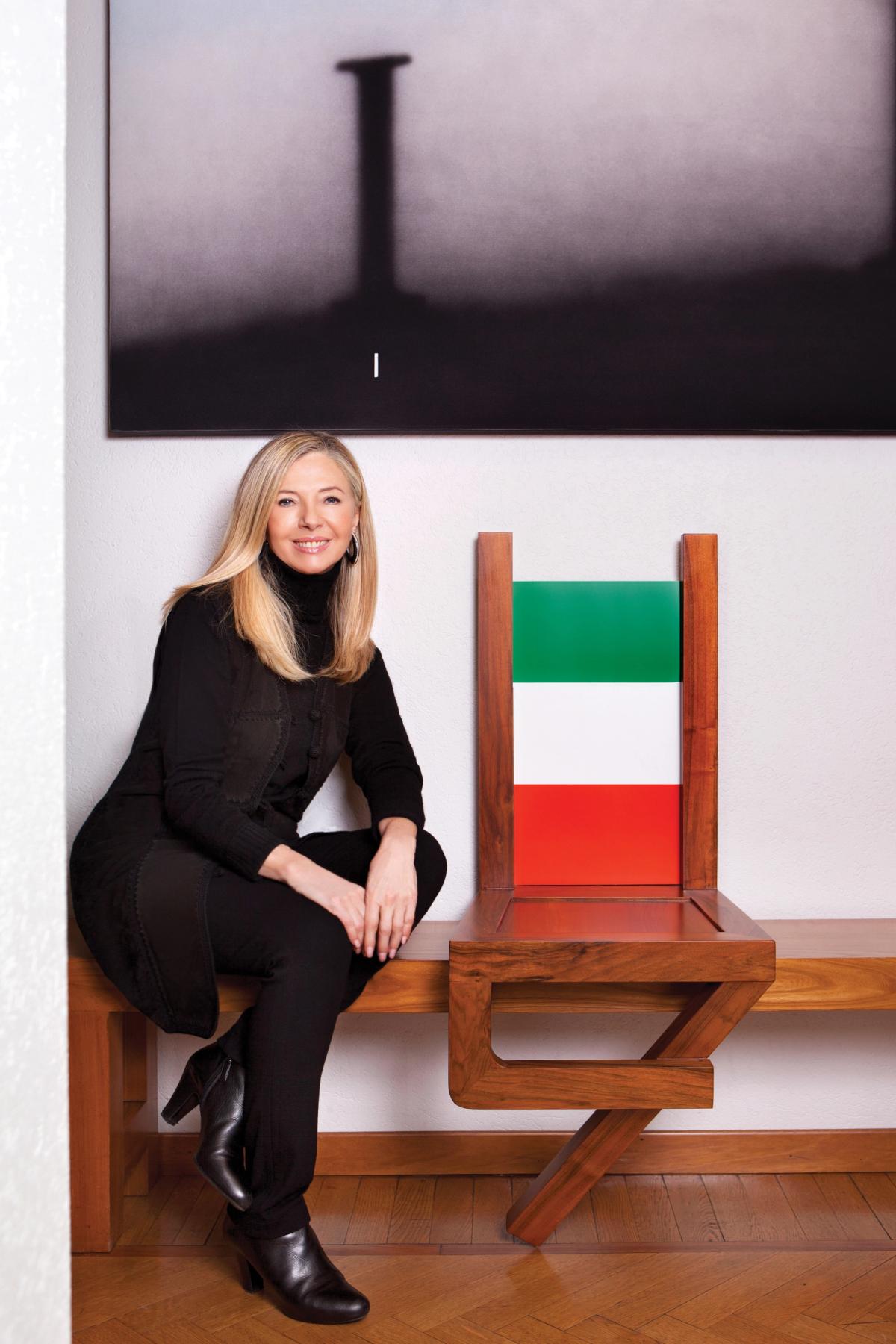Gemma De Angelis Testa inside her home with a work by her late husband Armando Testa (Sedia Antropomorfa, 1976) and Ed Ruscha's IF (1995) Photo: Barbara Corsico