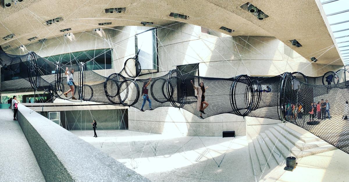 Visitors climb through Carsten Höller’s Decision Tubes (2019), mesh tunnels suspended in the atrium of the Museo Tamayo Photo: ©Gil Camargo/ @_gilcamargo