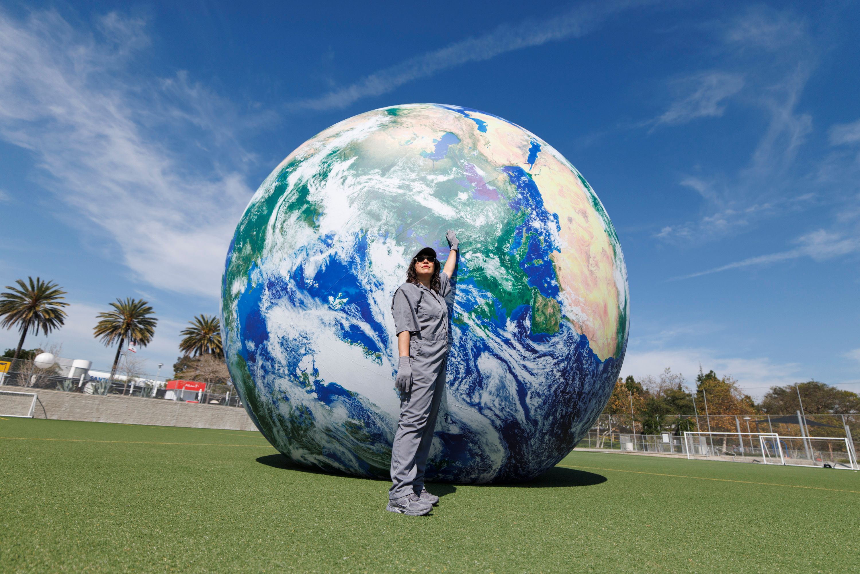 For her durational performance Untitled Orbit (MANUAL MODE) (2026), the artist Amanda Ross-Ho will push a 16ft inflatable Earth around the Santa Monica airport football pitch throughout the fair

Photo: Carlin Stiehl