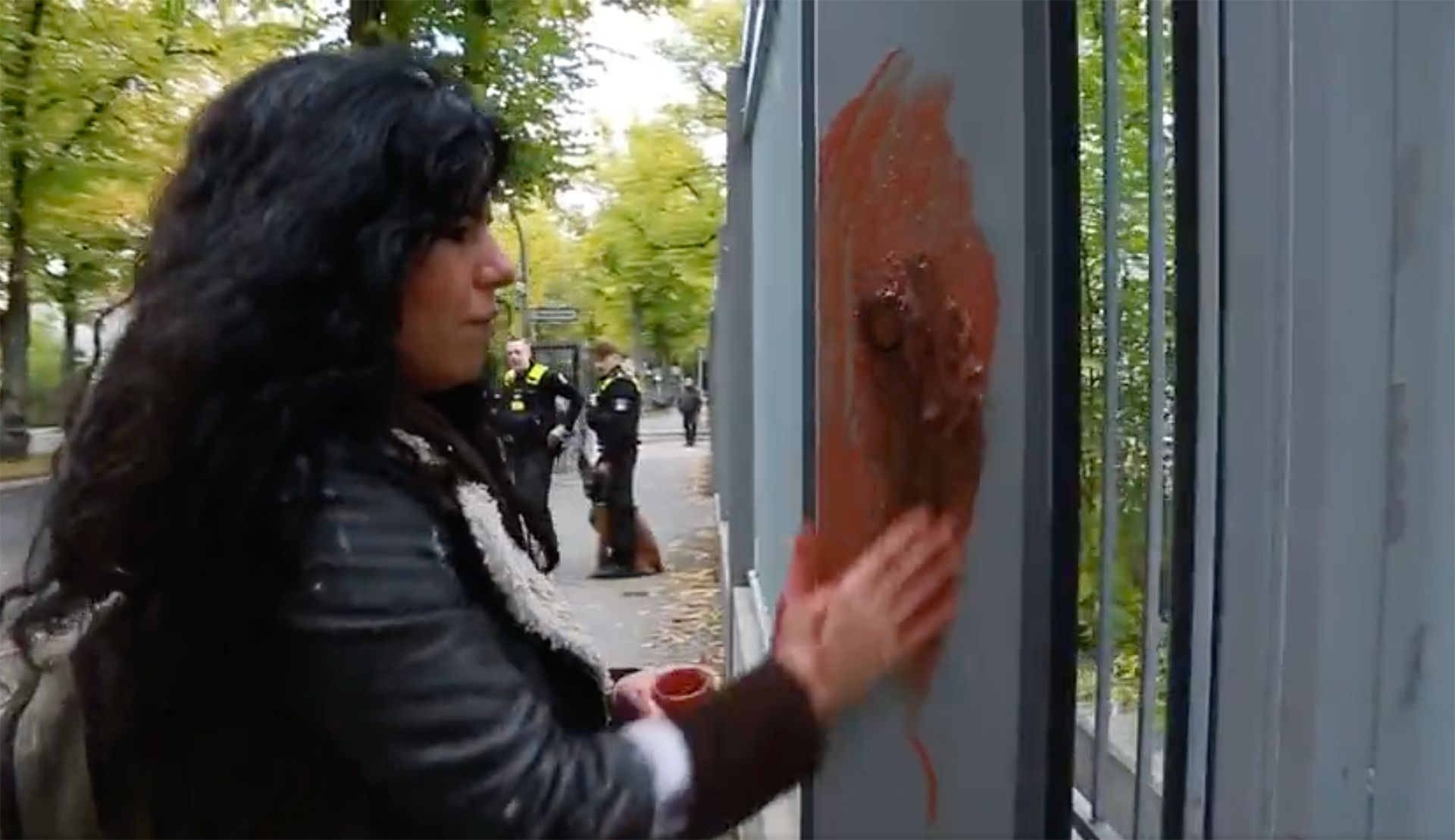 Artist Zehra Doğan stages a protest performance at the Iranian embassy in Berlin against the death of Mahsa Amini Screenshot via Twitter
