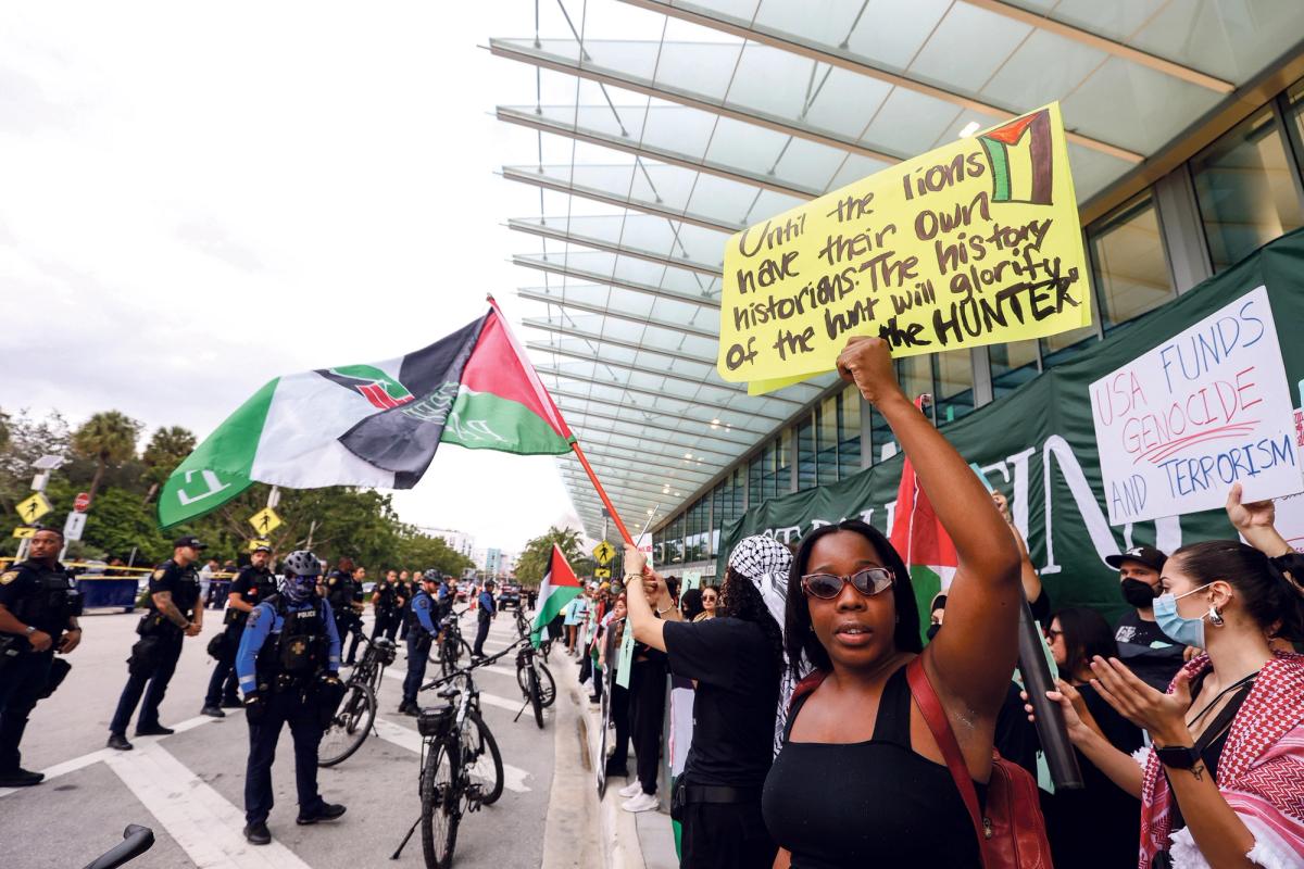 Activists protesting outside the convention centre on Friday were closely watched by dozens of police officers © Liliana Mora