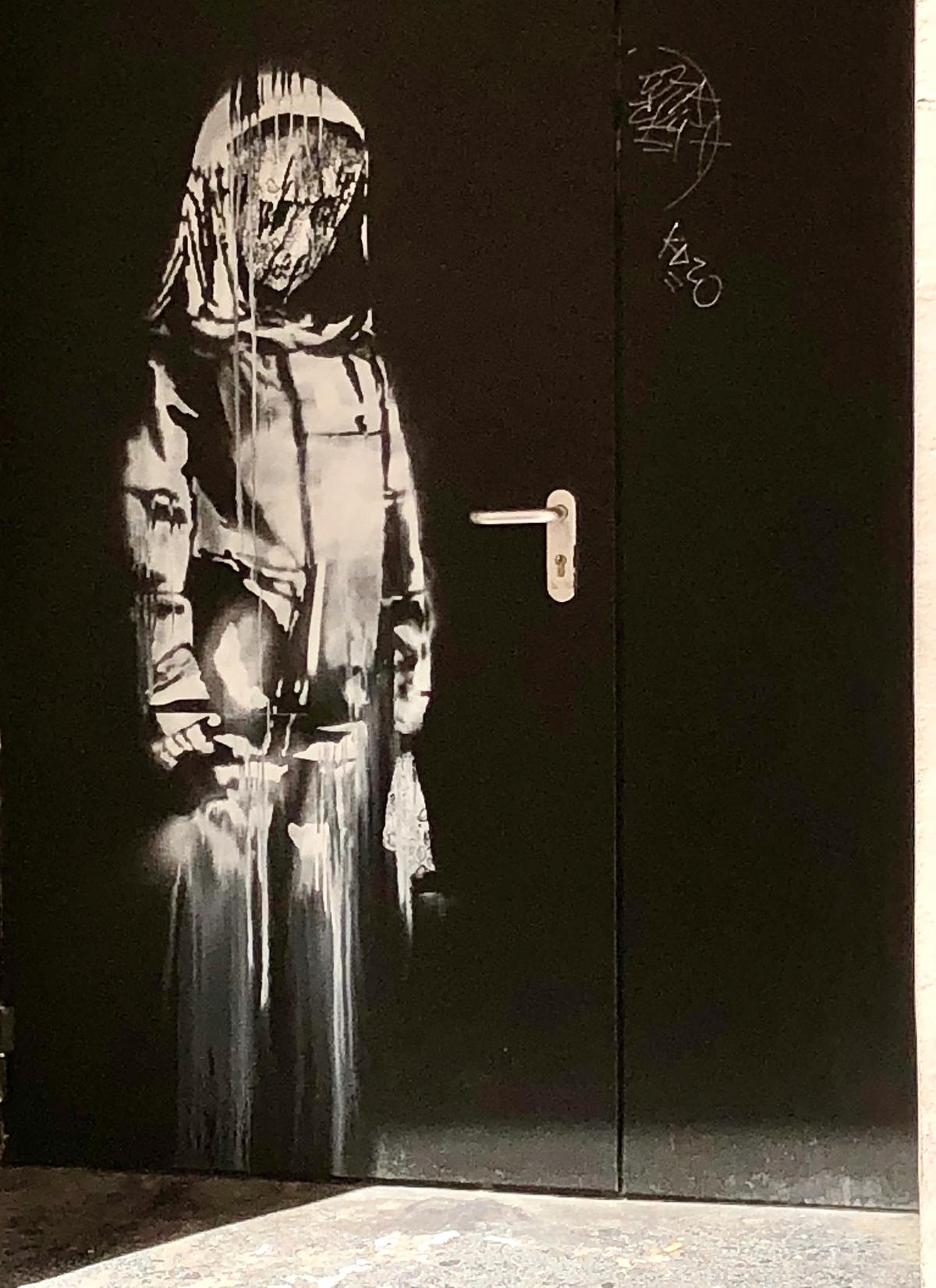 Banksy angel on a fire door at the Bataclan Photo by lar3 via Flikr