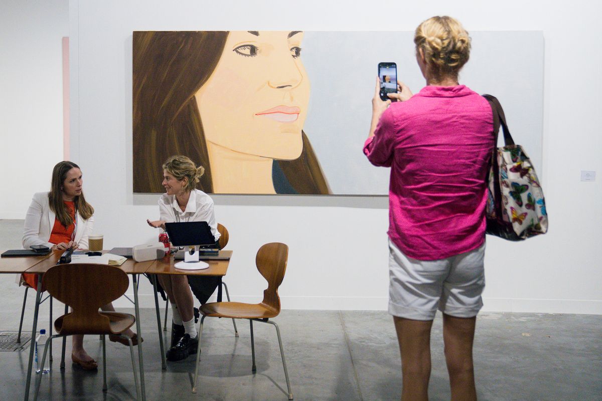 A visitor photographs an Alex Katz painting at the 2022 edition of Art Basel in Miami Beach Photo by Eric Thayer for The Art Newspaper