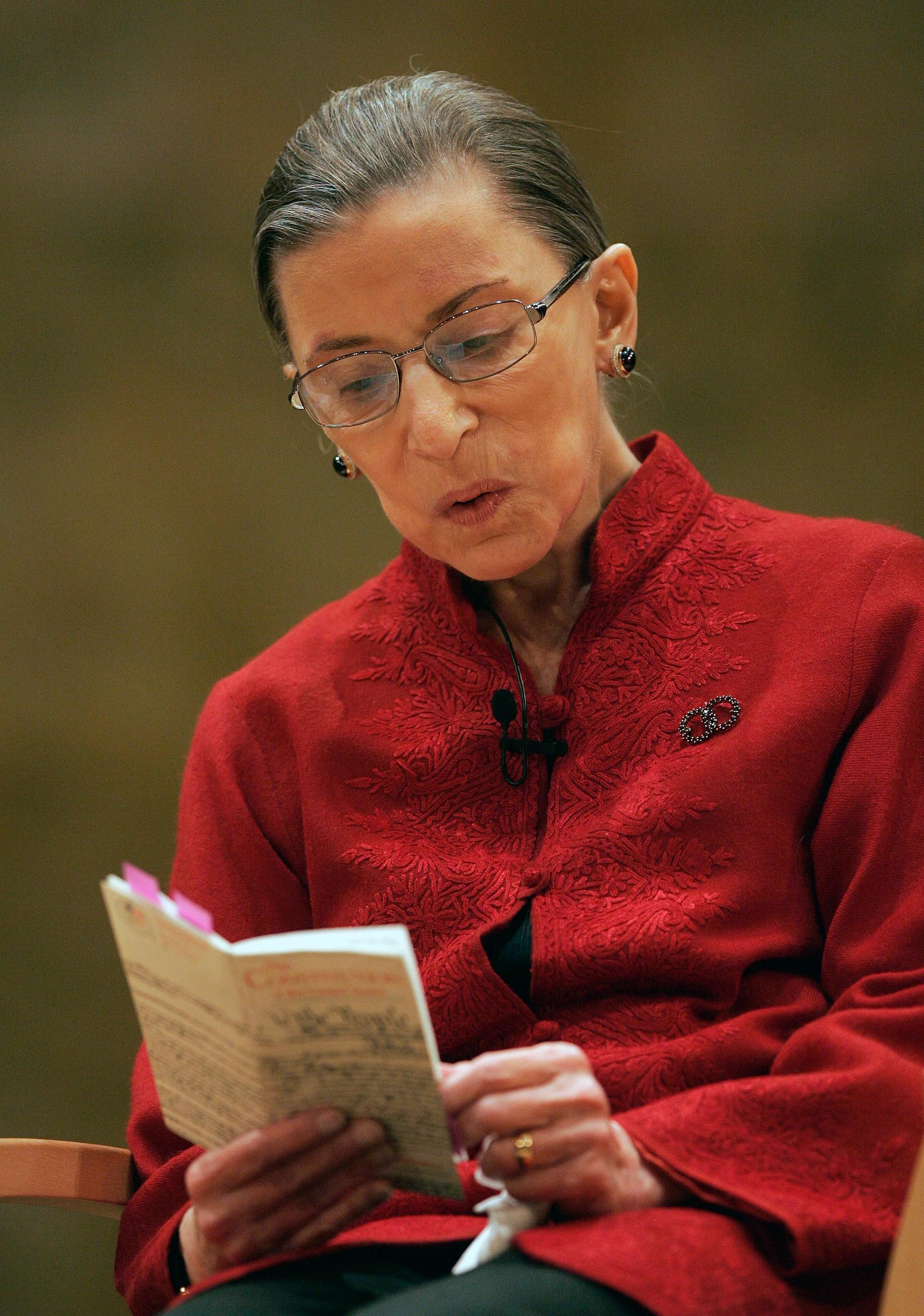 Supreme Court Justice Ruth Bader Ginsburg reads from a small book form of the U.S. Constitution while talking about constitutional law on 23 October 2008 in Princeton, NJ AP Photo/Mel Evans