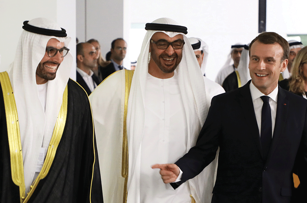 (From left to right) Chairman of Abu Dhabi's Tourism and Culture Authority, Mohamad Khalifa al-Mubarak, Abu Dhabi Crown Prince Mohammed bin Zayed al-Nahyan and French President Emmanuel Macron as they visit the Louvre Abu Dhabi Museum during its inauguration in Abu Dhabi REUTERS/Ludovic Marin/Pool
