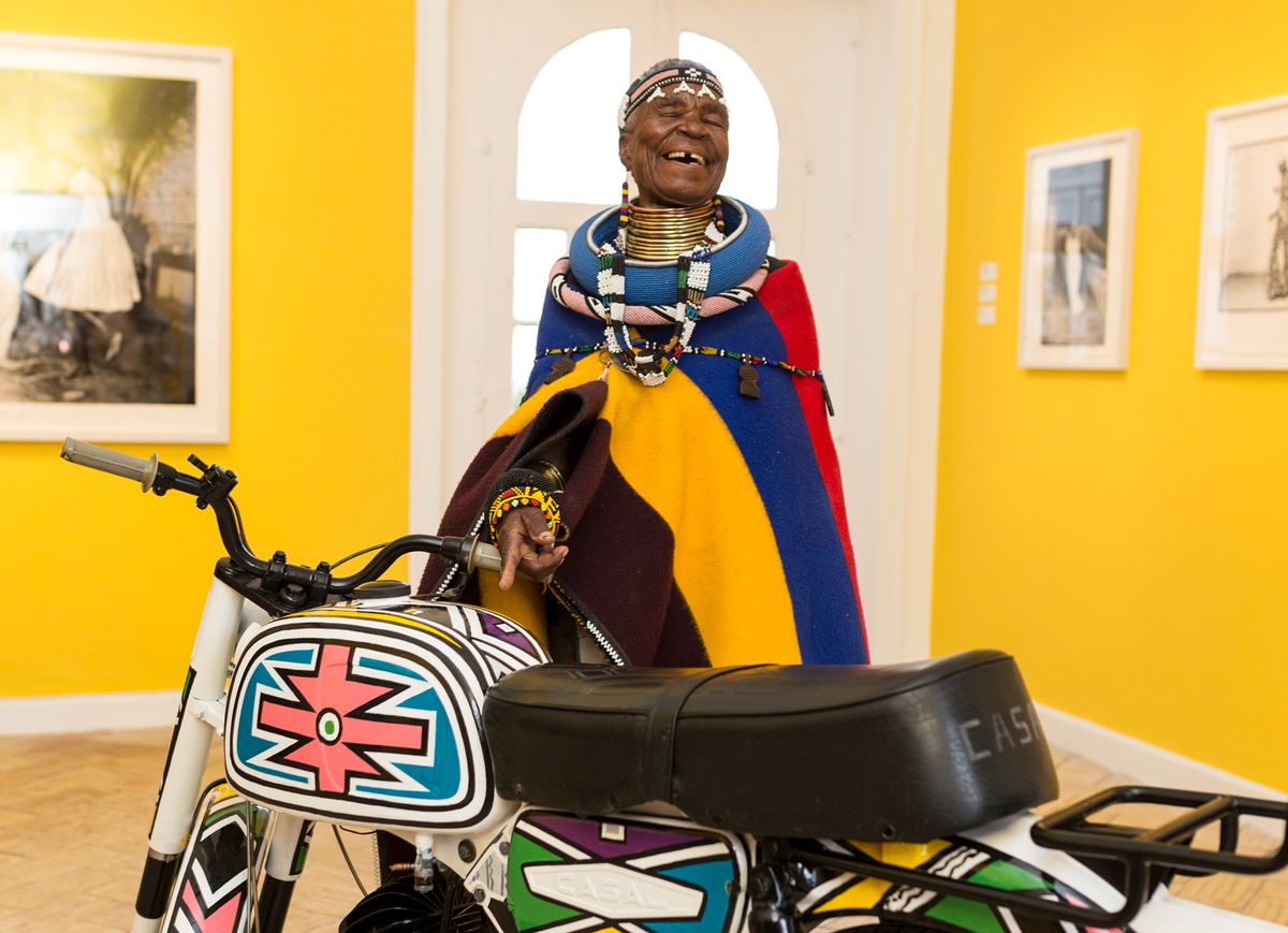 Esther Mahlangu with the motorbike she has decorated for the exhibition African Passions, part of the inaugural Evora Africa festival in the Alentejo region of Portugal African Passions, Palacio Cadaval, 2018