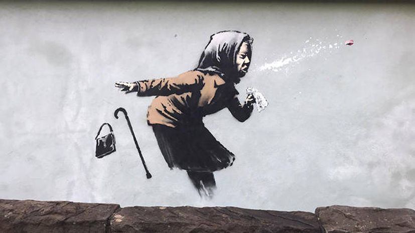 Cover your mouth! Banksy claims mural of sneezing woman in Bristol