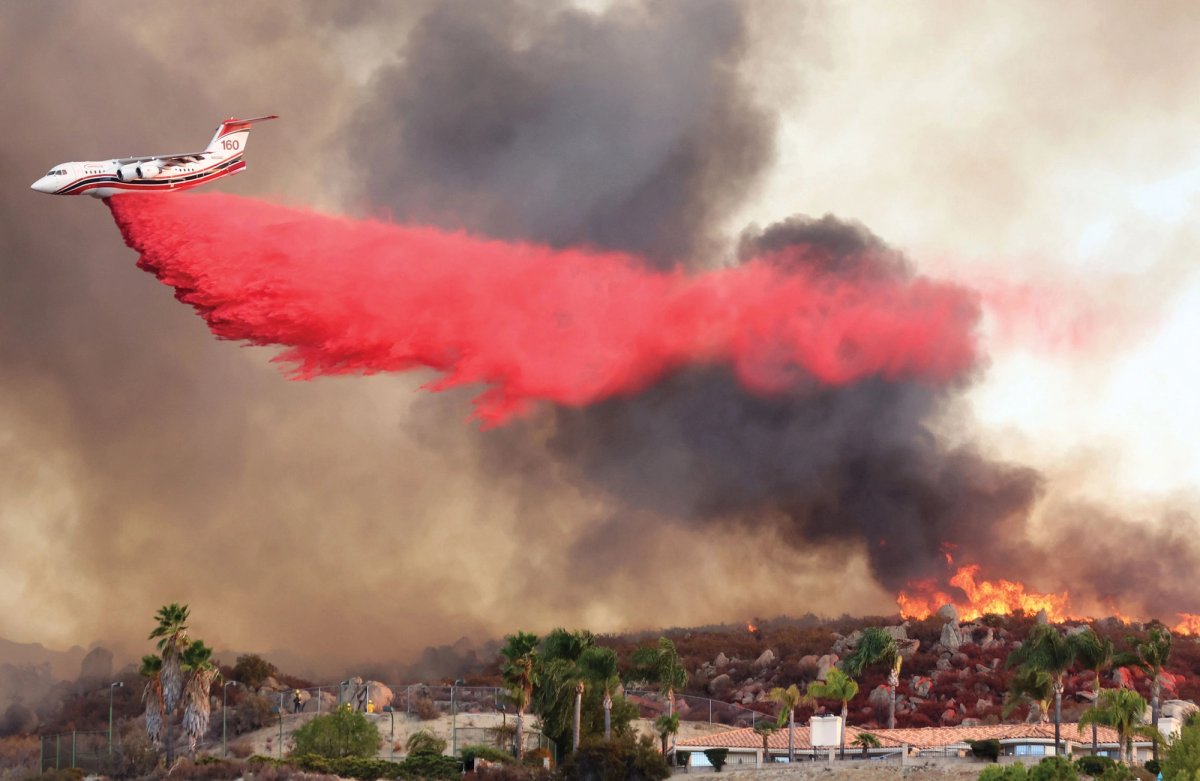 Red alert: a plane drops fire retardant on a wildfire in Southern California last month. Climate changes are causing ever more widespread and destructive fires in the state
Photo: Mario Tama/Getty Images