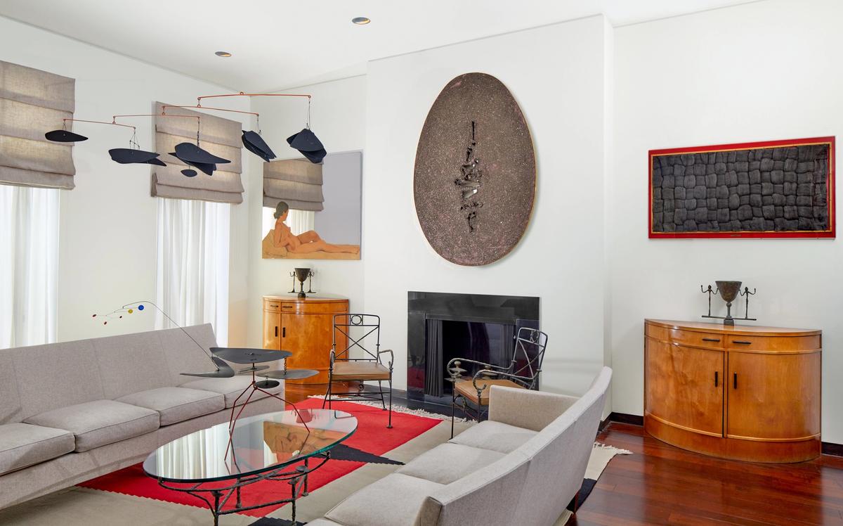 Daniella Luxembourg's New York townhouse, designed by Jacques Grange, featuring Fontana's Fine di Dio above the fireplace, and an Alexander Calder mobile which is also included in the Sotheby's sale
Courtesy of Sotheby's
