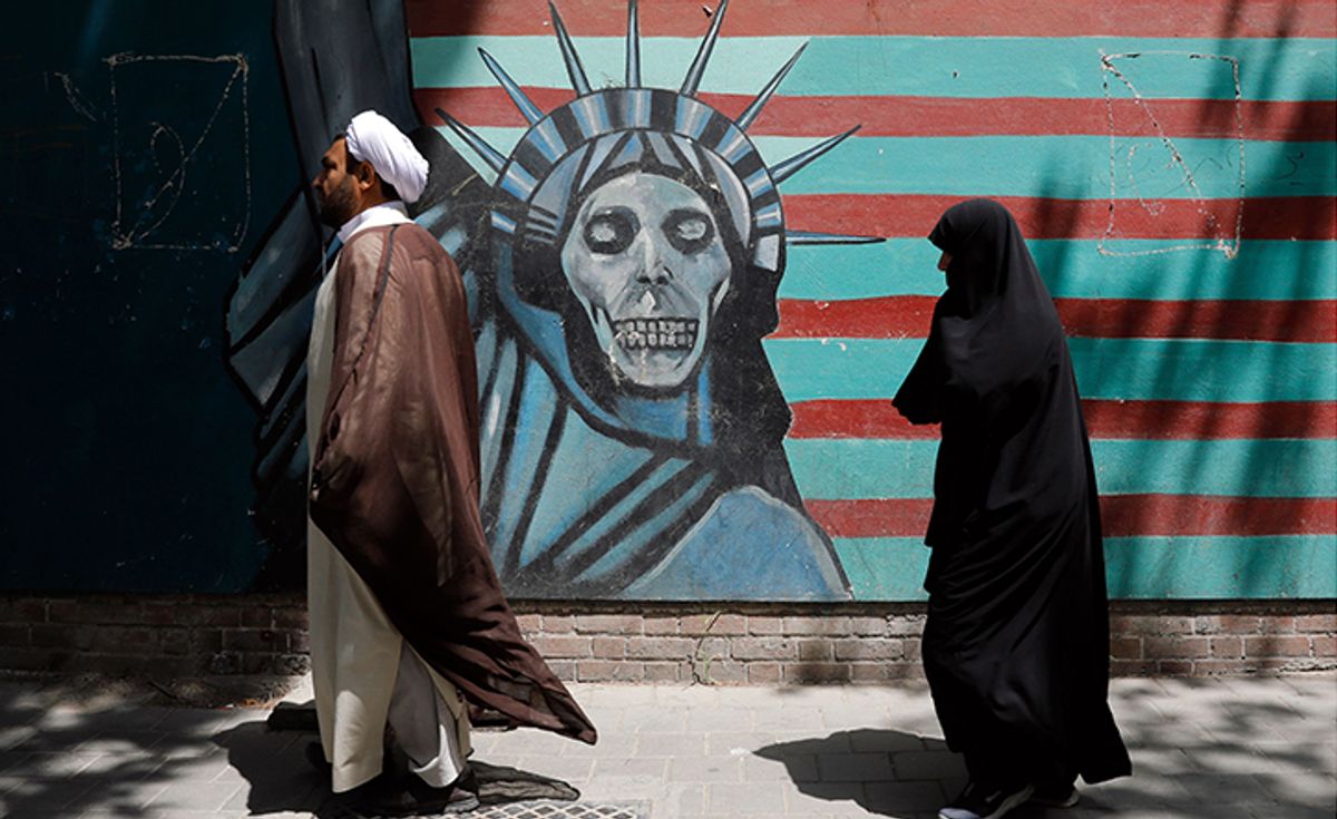 An Iranian cleric and woman walk past an anti-US mural during an anti-US and Israeli protest outside the former US embassy in Tehran on 16 May 2018 Abedin Tahrkenareh/EPA-EFE/REX/Shutterstock