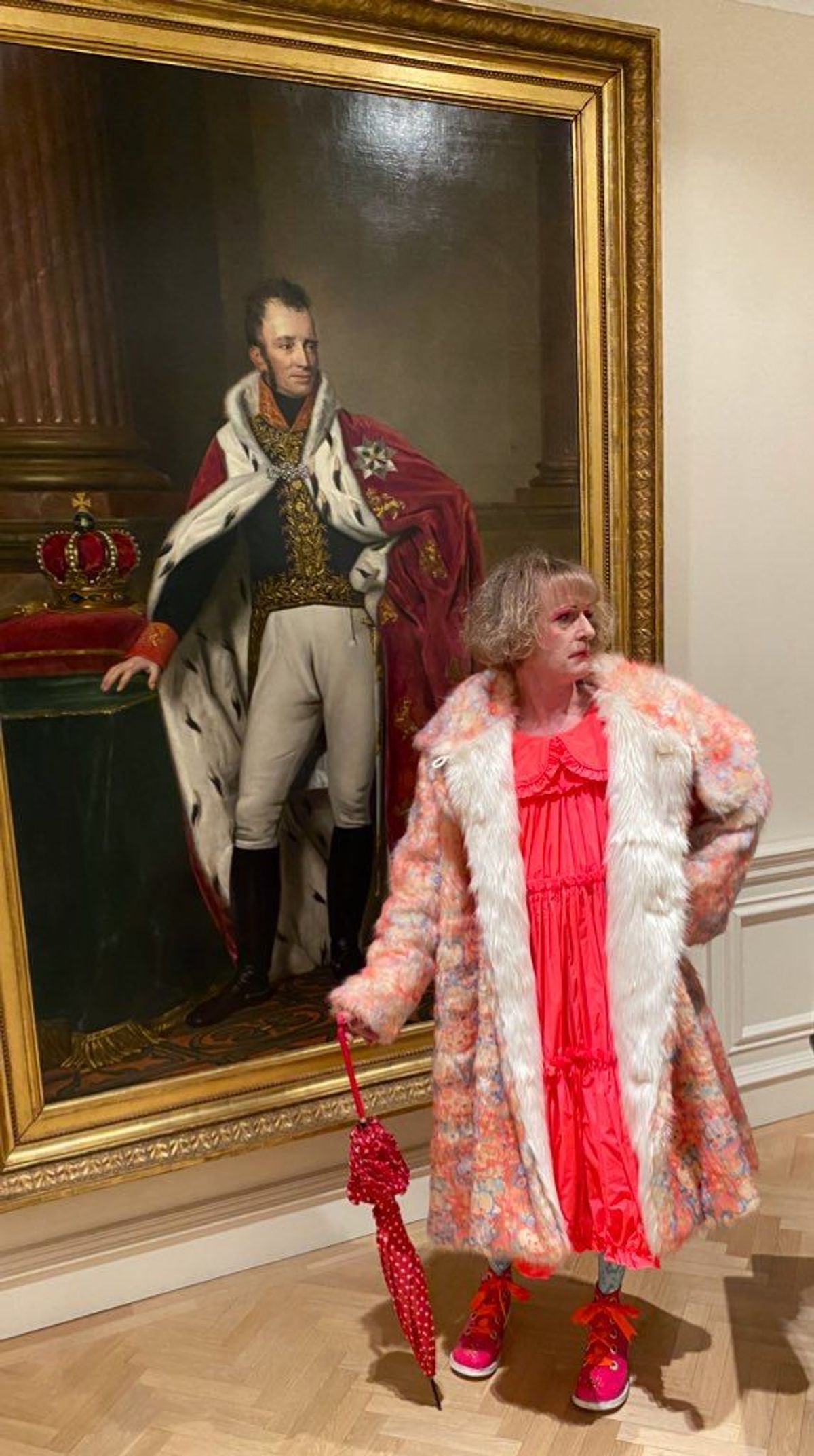 Grayson Perry poses alongside the art at the Dutch ambassador's residence in London