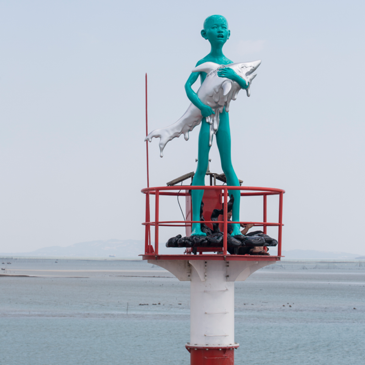 A detail of Chen Wenling's bronze and steel sculpture Boy Holding A Shark (2021) due to be installed on the South False Creek Seawall in Vancouver