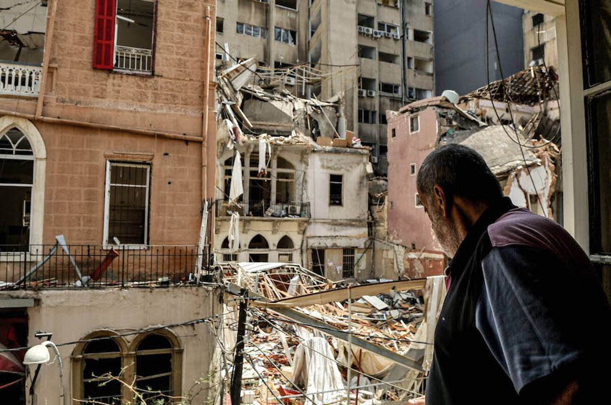 A man stares from a window towards the ruins of a heritage building in the Mar Mikhael neighbourhood, one of several historic districts in Beirut that bore the brunt of the explosion Marwan Naamani/dpa/Alamy Live News