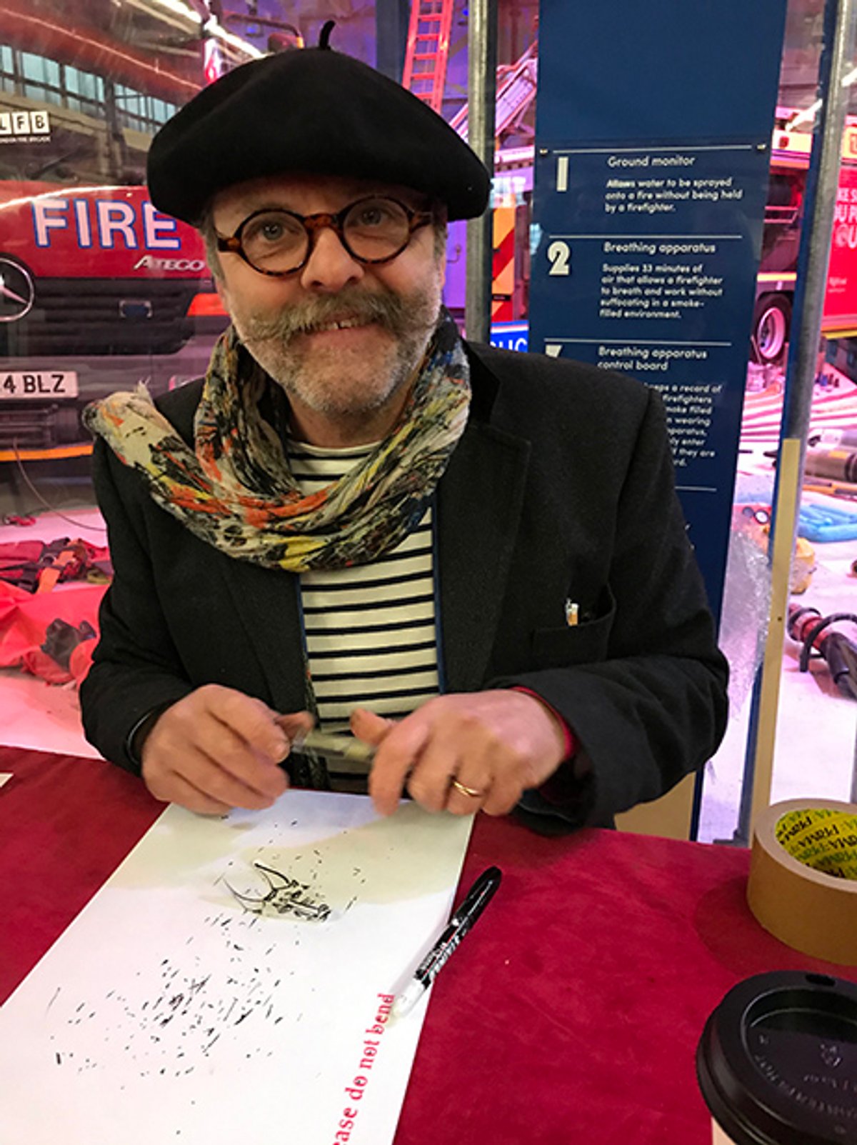 Gavin Turk at his booth at the Art Car Boot Fair Courtesy of Louisa Buck