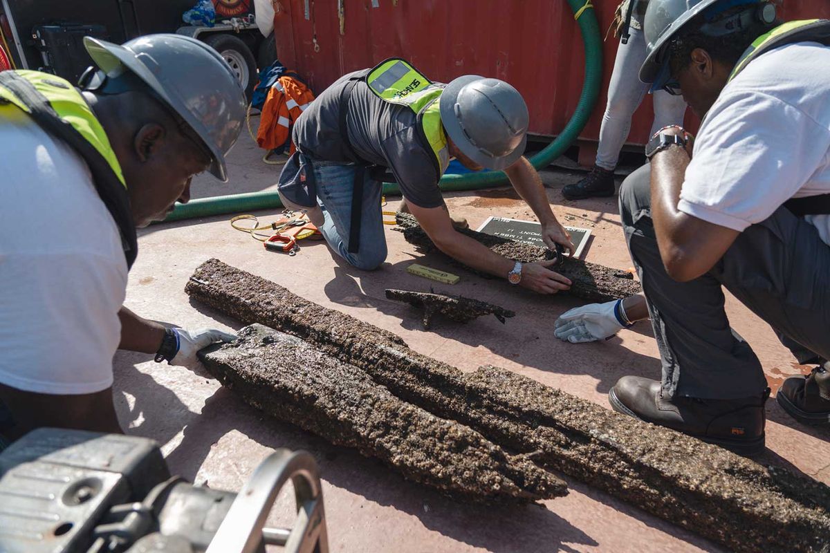 Workers assess the state of timbers from the wreck of the Clotilda, which was scuppered in the Mobile River in 1860 to conceal its crime of trafficking enslaved people

Photo: courtesy of Alabama Historical Commission