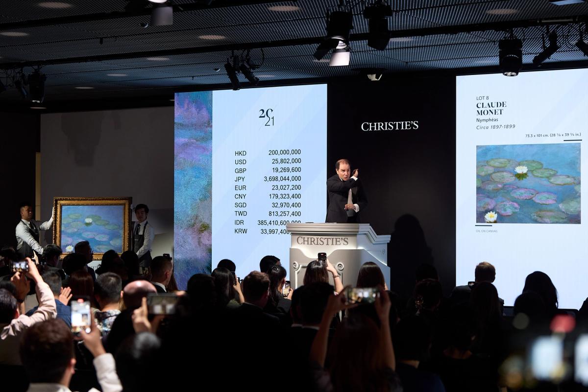 Auctioneer Adrien Meyer selling Claude Monet's Nymphéas (around 1897-99) in Hong Kong today Courtesy of Christie's