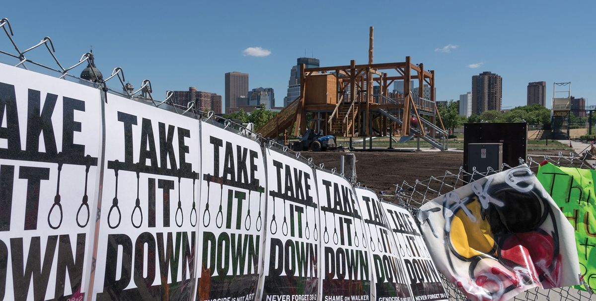 Protest signs line the perimeter fence around the Walker's sculpture garden after it installed Sam Durant's Scaffold Photo: Lorie Shaull
