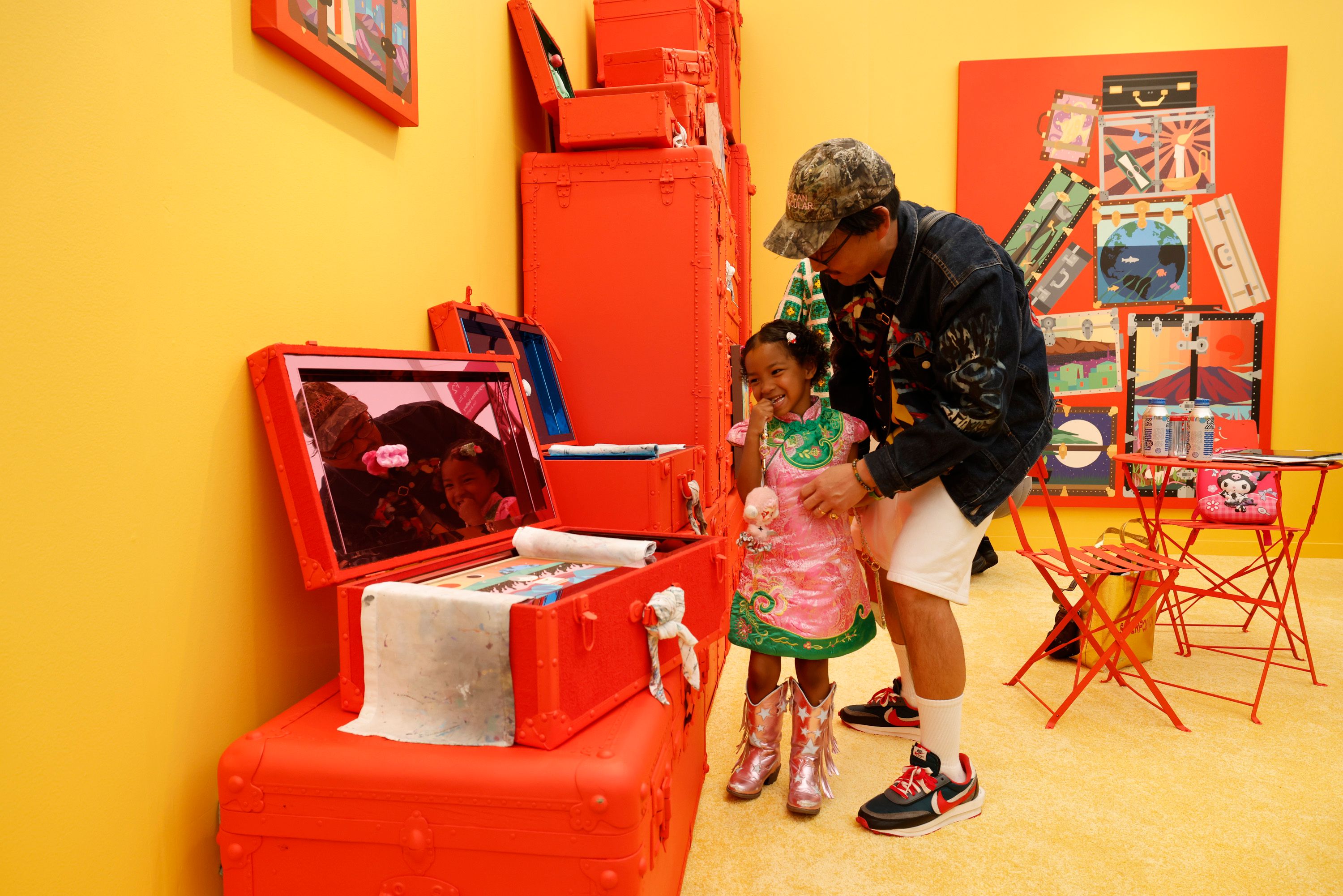 Generational: Greg Ito shows work from his installation at Superposition Gallery’s stand to his daughter Photo: Carlin Stiehl
