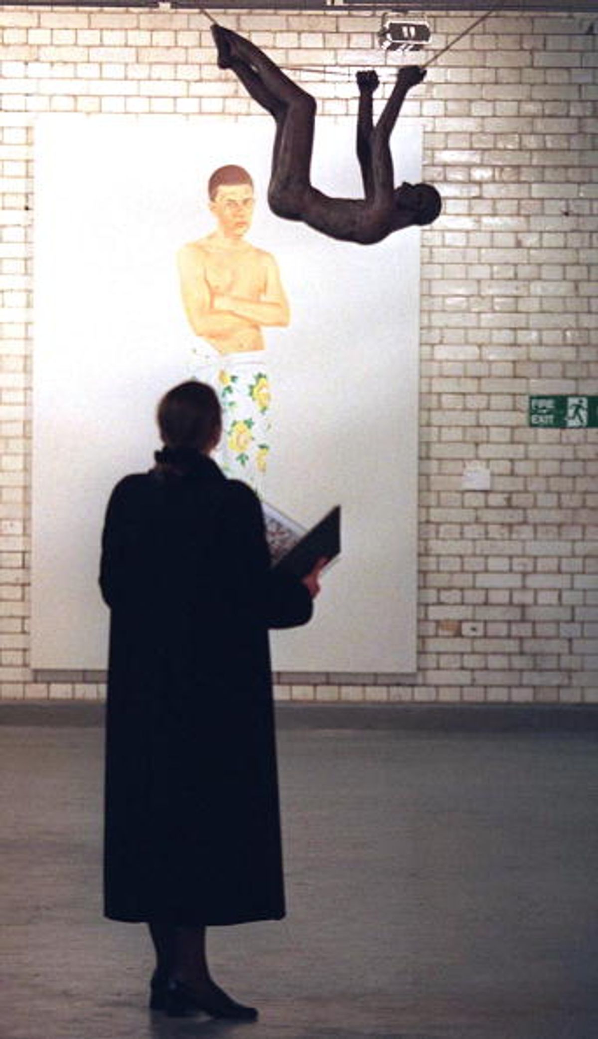 A visitor takes a look 14 April at "Hanging Man" by John Davies during a 14 April preview at a deserted London warehouse organized by Christie's auction house Photo: JOHNNY EGGITT/AFP via Getty Images